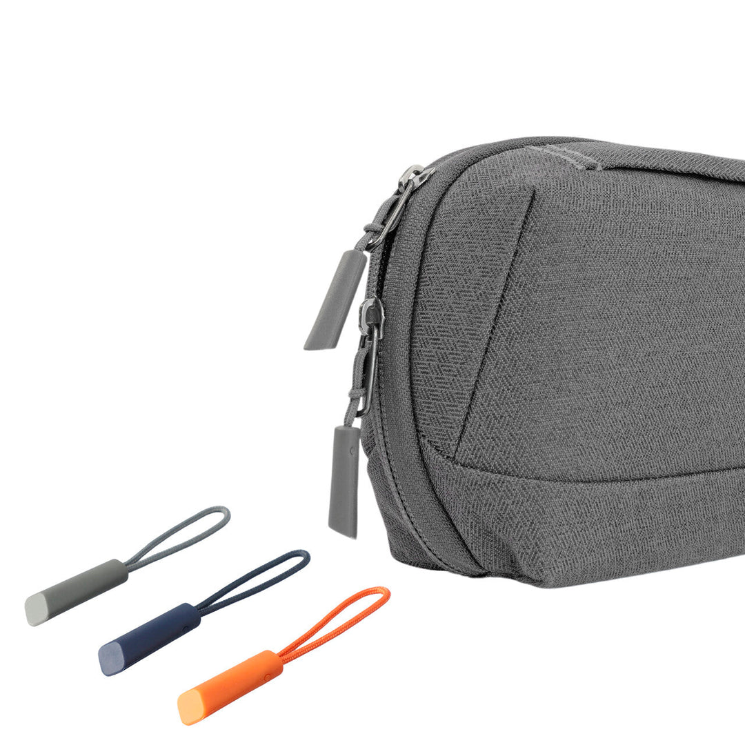 Smart Tech-Pouch Multiangle grau (D541270) Bild 3: Detailansicht eines Reißverschlusses des Smart Tech-Pouch Multiangle in grau mit einem Fokus auf die verschiedenen farbigen Reißverschlussbänder, die für eine einfache Handhabung sorgen. Die Farben der Bänder betonen die Anpassungsfähigkeit und den Stil der Tasche.